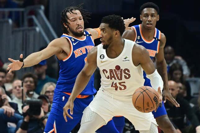 Mar 31, 2023; Cleveland, Ohio, USA; Cleveland Cavaliers guard Donovan Mitchell (45) is defended by New York Knicks guard Jalen Brunson (11) during the first half at Rocket Mortgage FieldHouse.