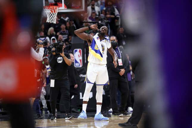 Golden State Warriors’ Draymond Green listens to the crowd after Green stomped on Sacramento Kings’ Domantas Sabonis