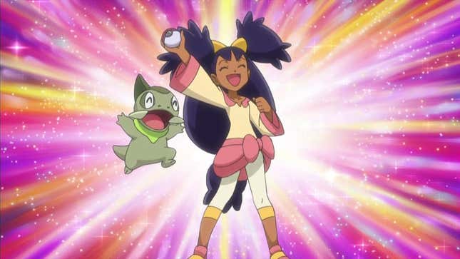 Iris is seen holding up a Pokeball alongside her Axew.