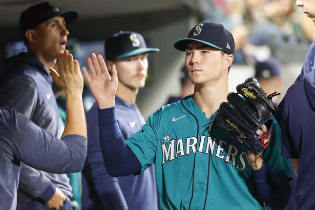 Sep 12, 2023; Seattle, Washington, USA; Seattle Mariners starting pitcher Bryan Woo (33) high-fives teammates and staff in the dugout during a sixth inning pitching change against the Los Angeles Angels at T-Mobile Park.