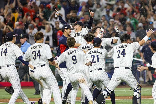 Mar 20, 2023; Miami, Florida, USA; Team Japan celebrates on the field after winning the game with a walk-off double from Japan third baseman Munetaka Murakami (55) during the ninth inning against Mexico at LoanDepot Park.