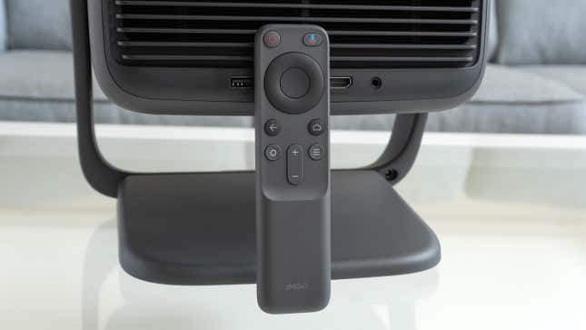 The JMGO N1 Ultra's wireless remote leaning against the back of the projector.
