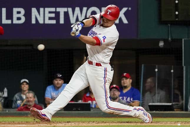 Apr 10, 2023; Arlington, Texas, USA;  Texas Rangers shortstop Corey Seager (5) hits a single during the eighth inning against the Kansas City Royals at Globe Life Field.