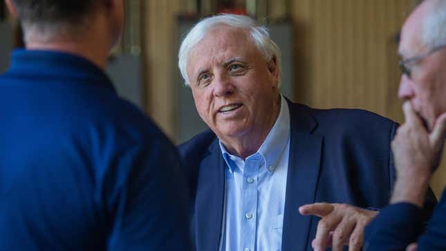 Gov. Jim Justice, center, speaks to Merl Wooten, owner of Wooten Machine Co., left, and Dr. Matthew Rohrbach while visiting community members to talk about the impact of the recent flood on Monday, May 9, 2022, in Huntington, W.Va. (Ryan Fischer/The Herald-Dispatch via AP)