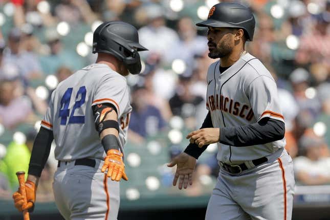 Apr 15, 2023; Detroit, Michigan, USA;  San Francisco Giants first baseman LaMonte Wade Jr. (right) celebrates with fielder Matt Beaty (left) after scoring against the Detroit Tigers in the first inning at Comerica Park.