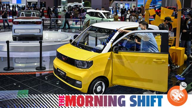 People look at a Wuling Hong Guang Mini EV during the 19th Shanghai International Automobile Industry Exhibition in Shanghai on April 20, 2021. (Photo by Hector RETAMAL / AFP) (Photo by HECTOR RETAMAL/AFP via Getty Images)
