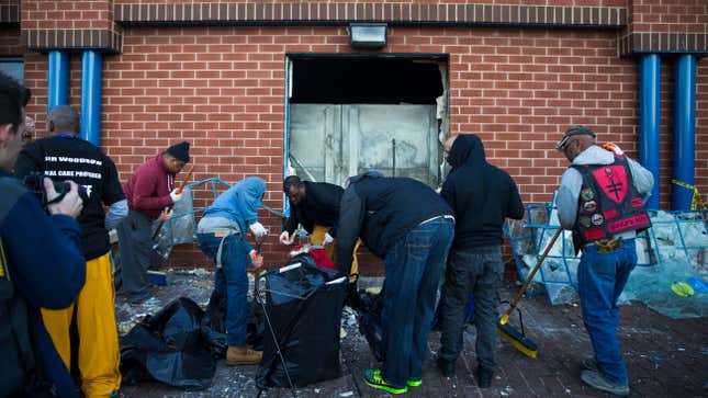 Residents help with the cleanup at a CVS that was looted on April 27.