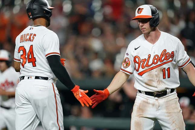 Jun 26, 2023; Baltimore, Maryland, USA; Baltimore Orioles outfielder Aaron Hicks (34) greeted by second baseman Jordan Westburg (11) after scoring a run in the sixth inning against the Cincinnati Reds at Oriole Park at Camden Yards.