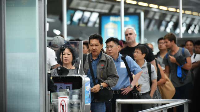 people waiting in security line at an airport