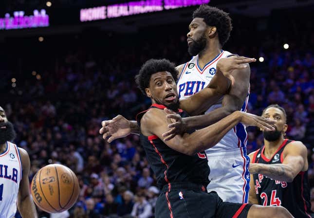 Dec 19, 2022; Philadelphia, Pennsylvania, USA; Toronto Raptors forward Thaddeus Young (21) looses control of the ball while driving against Philadelphia 76ers center Joel Embiid (21) during the second quarter at Wells Fargo Center.