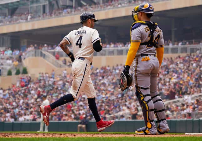 Jun 14, 2023; Minneapolis, Minnesota, USA; Minnesota Twins shortstop Carlos Correa (4) scores against the Milwaukee Brewers in the third inning at Target Field.