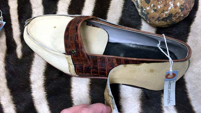 A Cayman crocodile skin shoe hidden behind cheap leather covering.