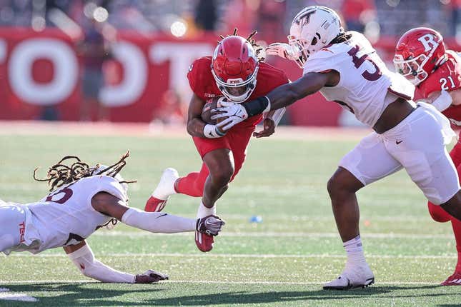 Sep 16, 2023; Piscataway, New Jersey, USA; Rutgers Scarlet Knights quarterback Gavin Wimsatt (2) is tackled by Virginia Tech Hokies safety Jalen Stroman (26) and defensive lineman Antwaun Powell-Ryland (52) during the first half at SHI Stadium.