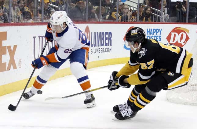 Mar 9, 2023; Pittsburgh, Pennsylvania, USA;  New York Islanders defenseman Sebastian Aho (25) moves the puck against Pittsburgh Penguins right wing Rickard Rakell (67) during the first period at PPG Paints Arena.