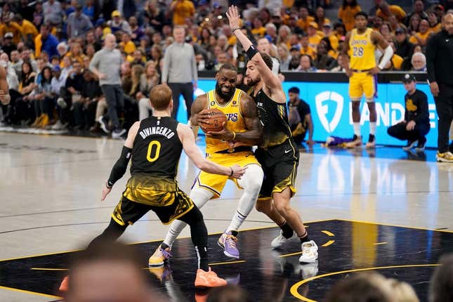 May 2, 2023; San Francisco, California, USA; Los Angeles Lakers forward LeBron James (6) drives to the hoop between Golden State Warriors guard Donte DiVincenzo (0) and guard Klay Thompson (11) in the second quarter during game one of the 2023 NBA playoffs at the Chase Center.