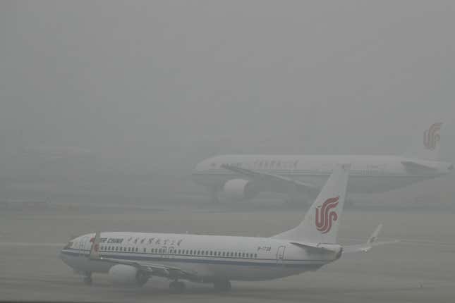 Air China passenger planes preparing to take off at the Beijing Capital International Airport as the capital of China is shrouded by heavy smog on Dec.21, 2016. Beijing and much of industrial northern China are in the midst of a "red alert," the highest level in China's four-tiered pollution warning system. The alert has affected 460 million people, according to Greenpeace East Asia, which calculated that about 200 million people were living in areas that had experienced levels of air pollution more than 10 times above the guideline set by the World Health Organization. (AP Photo/Andy Wong)