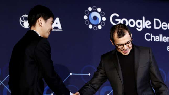  South Korean professional Go player Lee Se-Dol (L) shakes hands with Demis Hassabis (R) co-founder of Google's artificial intelligence (AI) startup DeepMind looks after finishing the final match of the Google DeepMind Challenge Match against Google's artificial intelligence program, AlphaGo, on March 15, 2016 in Seoul, South Korea.