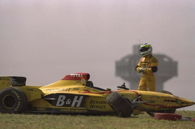 Giancarlo Fisichella of Italy stands by his broken down Jordan Peugeot during the 1997 Brazilian Grand Prix.