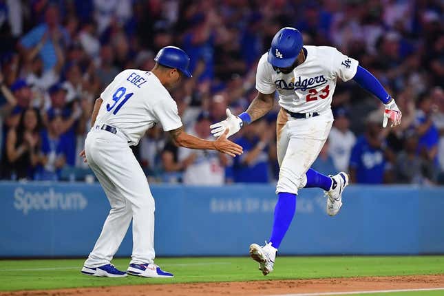 Aug 28, 2023; Los Angeles, California, USA; Los Angeles Dodgers right fielder Jason Heyward (23) is greeted by third base coach Dino Ebel (91) after hitting a two run home run against the Arizona Diamondbacks during the sixth inning at Dodger Stadium.