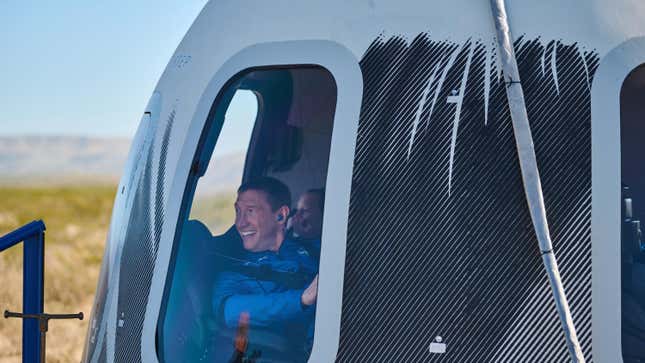 Glen de Vries looks out the crew capsule window after returning to Earth after a successful flight on New Shephard.