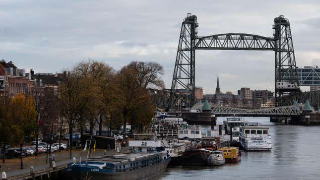A picture shows barges docked on the Koningshaven waterway as they Koningshavenbrug “De Hef” lift bridge (R, rear) and the Koninginnebrug drawbridge (R, front) are seen in the background in Rotterdam, western Netherlands, on November 23, 2021. 