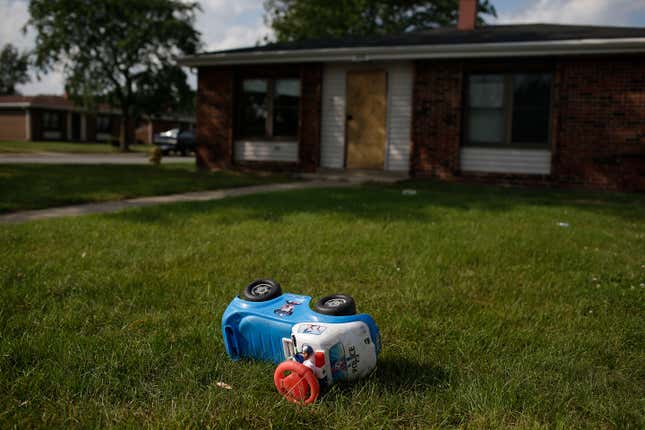 A toy police truck lays in the grass outside of a house at the West Calumet Housing Complex on September 5, 2016 in East Chicago, Indiana. The soil at the complex has been found to contain high levels of lead and arsenic putting all residents in danger if exposed to the elements. Over 1,000 residents are being asked by the East Chicago Housing Authority to relocate, after plans were decided to demolish the housing complex.