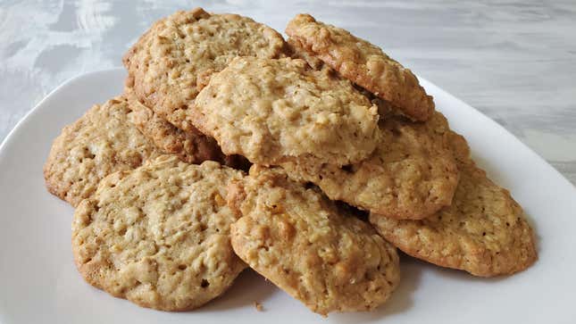 A pile of oatmeal scotchie cookies on a white plate
