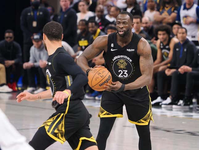 Mar 28, 2023; San Francisco, California, USA; Golden State Warriors center Draymond Green (23) controls the ball as he looks towards guard Stephen Curry (30) during the second quarter against the New Orleans Pelicans at Chase Center.