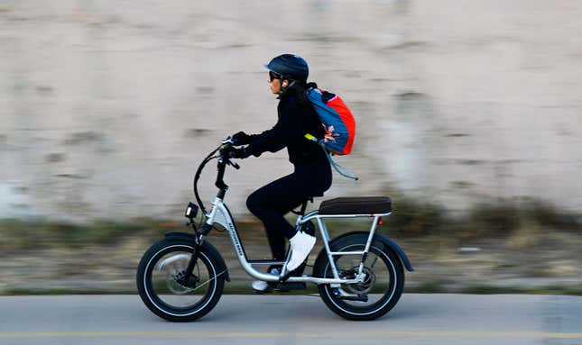 A photo of someone riding an electric bike. 