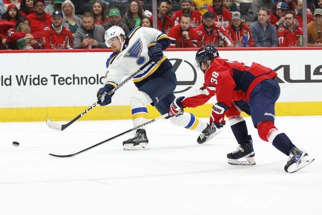 Mar 17, 2023; Washington, District of Columbia, USA; St. Louis Blues right wing Kasperi Kapanen (42) scores a goal as Washington Capitals defenseman Rasmus Sandin (38) defends in the second period at Capital One Arena.