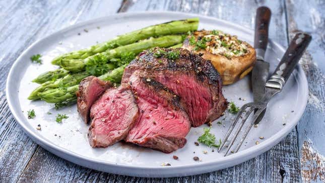 Steak on plate with grilled asparagus