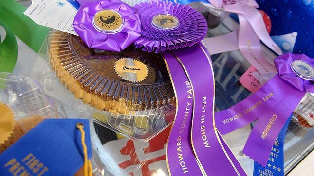 Purple Howard County Fair Best Of Show ribbon on plastic container of pie