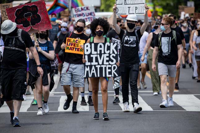 A black woman marches at the head of the group of members and allies of the LGBTQ community to the White House as part of the Pride and Black Lives Matter movements on June 13, 2020, in Washington, DC. 
