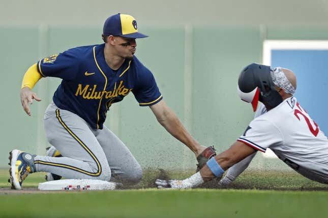 Jun 13, 2023; Minneapolis, Minnesota, USA; Milwaukee Brewers shortstop Willy Adames (27) tags out Minnesota Twins third baseman Royce Lewis (23) who tried to extend a single into a double in the second inning at Target Field.