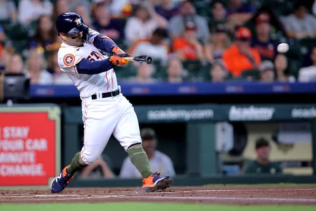 May 20, 2023; Houston, Texas, USA; Houston Astros second baseman Jose Altuve (27) hits a double against the Oakland Athletics during the first inning at Minute Maid Park.