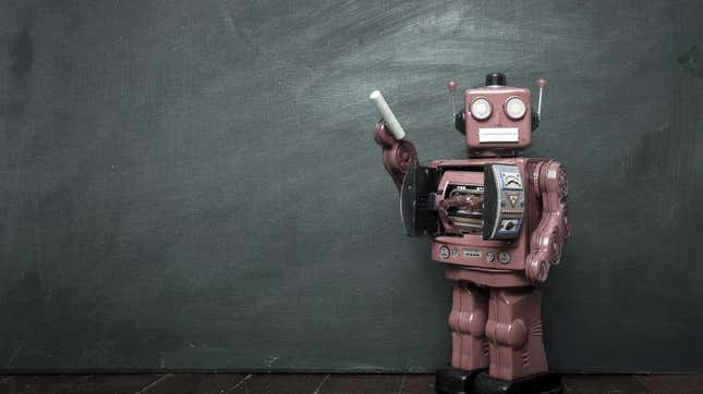 A robot holds a piece of chalk to a blackboard.