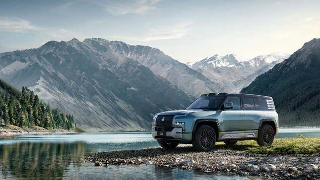 A photo of a YangWang U8 parked near a lake. 