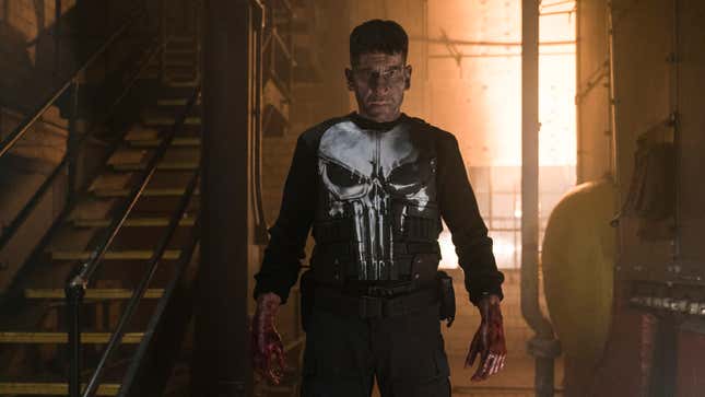 Jon Bernthal as The Punisher looking sullen with his hands covered in blood. He's wearing the Punisher uniform from the comics. 