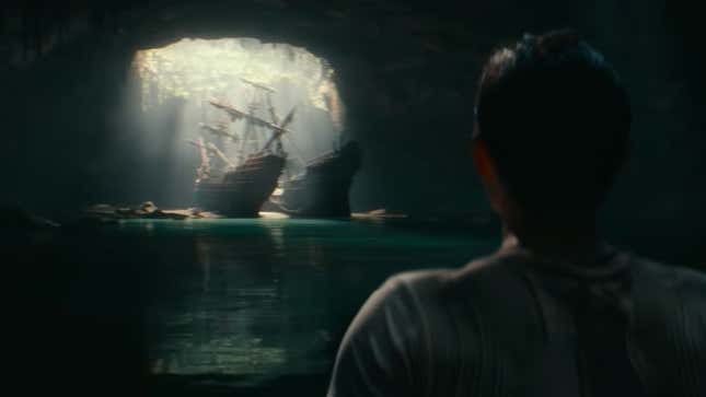 Nathan Drake looks at a pirate ship in an underground cave in the Uncharted movie.
