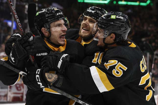 Mar 11, 2023; Boston, Massachusetts, USA; Boston Bruins right wing Garnet Hathaway (21) (left) is congratulated by defenseman Connor Clifton (75) and left wing A.J. Greer (10) after scoring the go ahead goal against the Detroit Red Wings during the third period at TD Garden.
