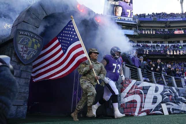 Nov 20, 2022; Baltimore, Maryland, USA;  Baltimore Ravens guard Ben Powers (72) takes the field with a member of the U.S. military for introductions before the game against the Carolina Panthers at M&amp;amp;T Bank Stadium.