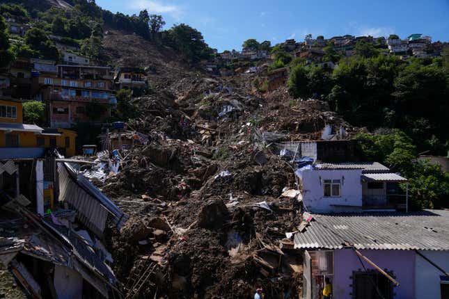 The path of a mudslide marks a hillside filled with homes.
