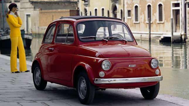 A photo of a red Fiat 500 small car. 