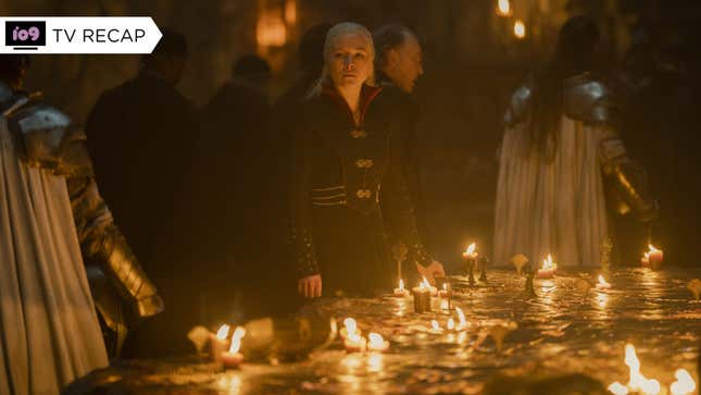 Queen Rhaenyra stands over a large map of Westeros which many candles have been placed upon.
