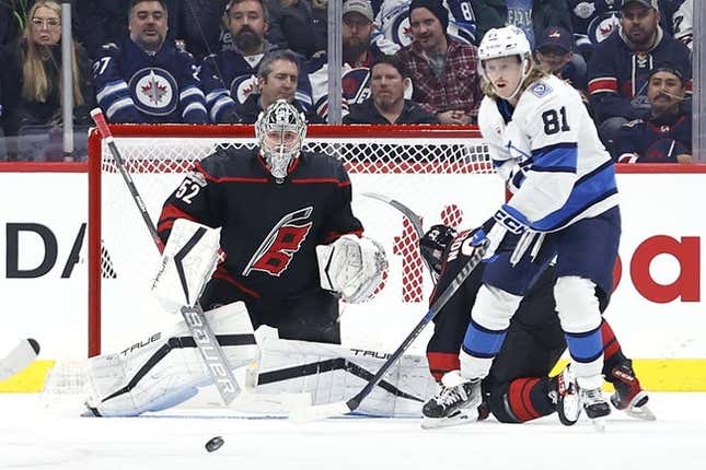 Nov 21, 2022; Winnipeg, Manitoba, CAN; Carolina Hurricanes goaltender Pyotr Kochetkov (52) and Winnipeg Jets left wing Kyle Connor (81) watch an incoming shot in the first period at Canada Life Centre.