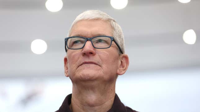 Apple CEO Tim Cook grimacing and looking off to the side.
