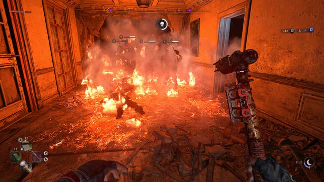 A small group of zombies on fire inside of a rundown building.