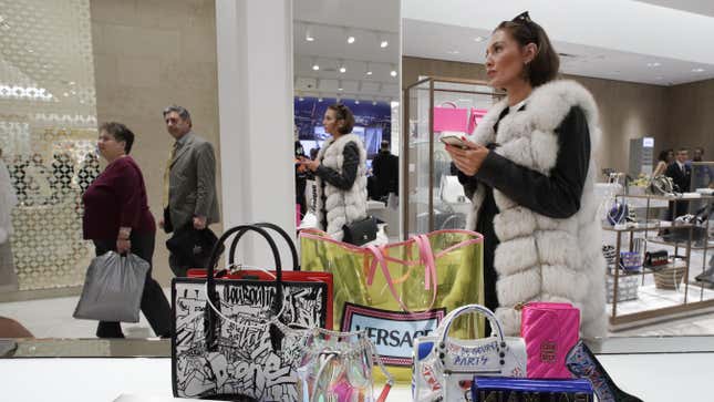 A woman in a furry vest shops at Neiman Marcus in New York