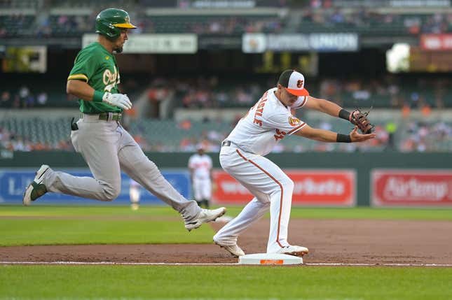 Apr 12, 2023; Baltimore, Maryland, USA;  Baltimore Orioles first baseman Ryan Mountcastle (6) holds secures the ball for the force out of Oakland Athletics third baseman Jace Peterson (6) in the second inning at Oriole Park at Camden Yards.