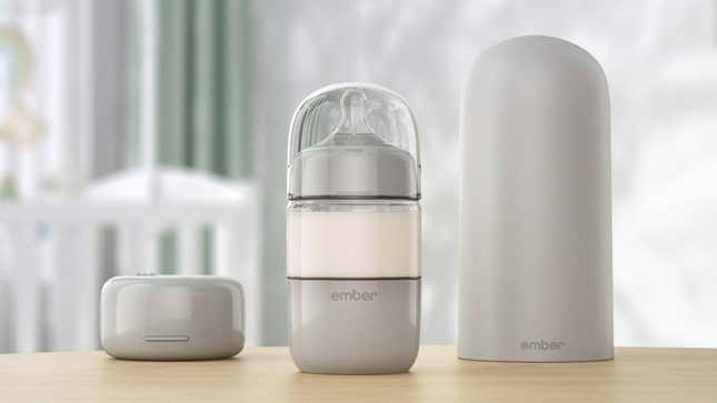 The Ember Baby Bottle System photographed on a wooden table in a child's nursery.